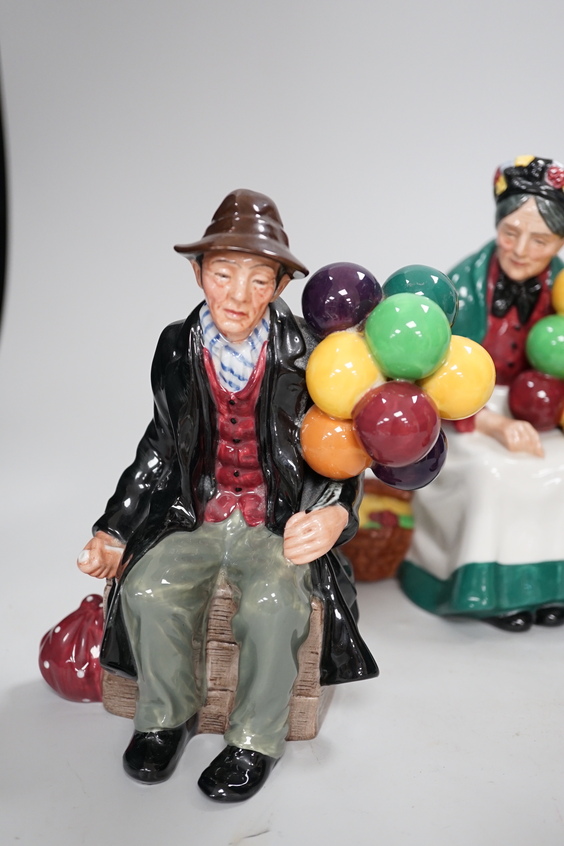 Three Royal Doulton figures comprising Lambing Time HN1890 and The Balloon man HN1954, the largest 23cm high